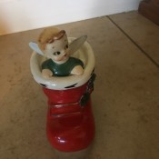 A figurine of a Christmas elf in a red boot.
