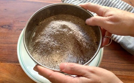 Straining the hot chocolate powder.