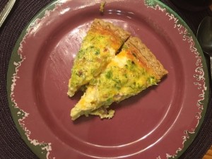 A plate with two slices of quiche.