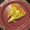 A plate with two slices of quiche.