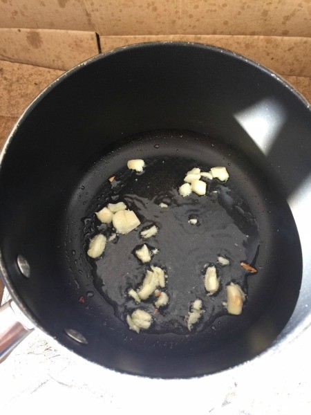 Sauteing garlic in a frying pan.