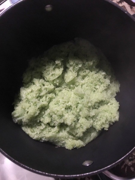 Mixing the rice with the additional coconut.