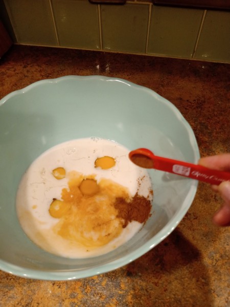 Adding cinnamon to the mixture.