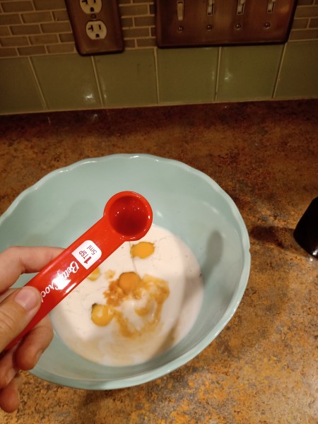 Adding vanilla to the mixture.