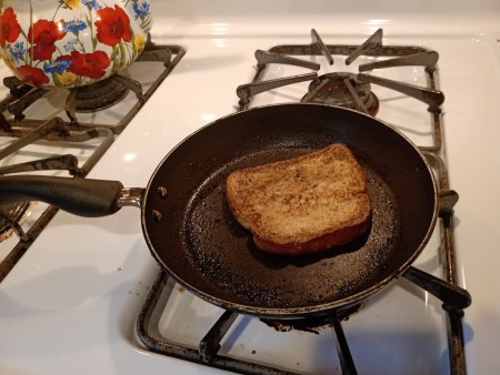 Cooking the French toast in a frying pan.