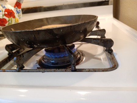 Cooking the French toast in a frying pan.