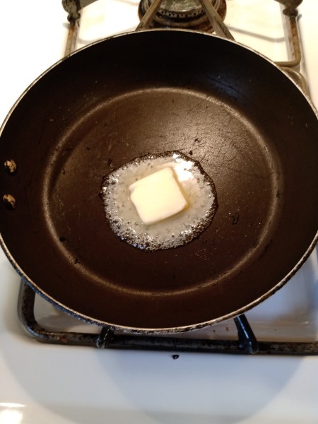 Melting butter in a frying pan.