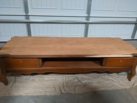 A low wooden table with drawers.