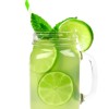 A glass jar filled with limeade and mint.