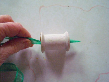 Threading the ribbon through the spool.