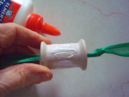 Putting glue on the thread spool.