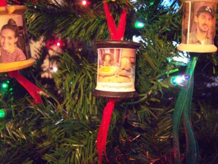Spool ornaments hanging on the tree.