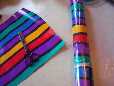 A roll of wrapping paper with the plastic wrapped replaced.