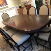 A large mahogany dining table with 8 chairs.