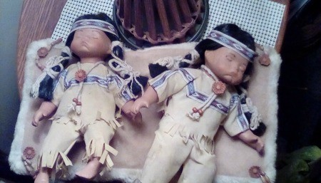 Two Native American porcelain dolls.