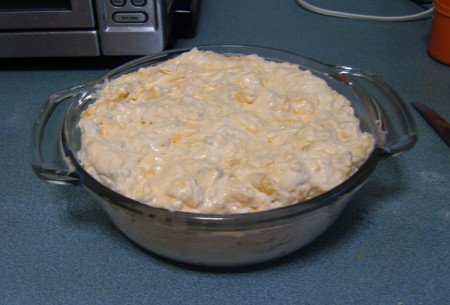 A glass container of orange pineapple fluff.