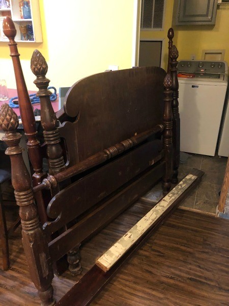 A wooden head and footboard with posts.
