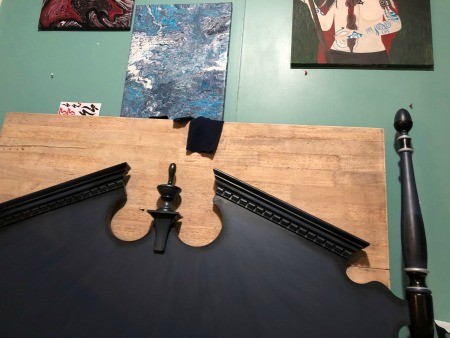 A black headboard with posts.