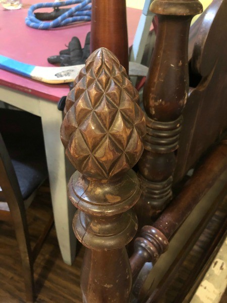 The carved posts on a mahogany bed.