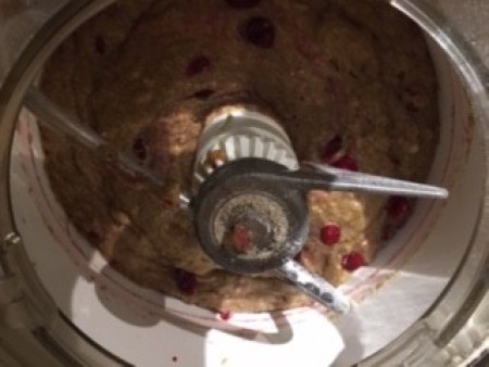 Mixing the cranberries into the bread.