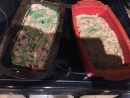 Two loaf pans filled with bread.