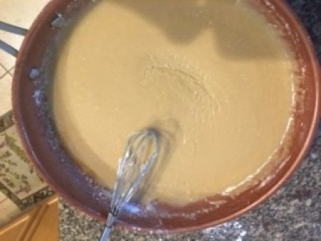 A bowl of icing for Caramel Apple Sweet Rolls