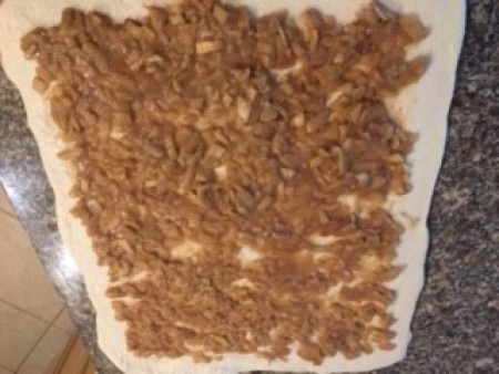 Apple mixture spread on the dough before rolling.