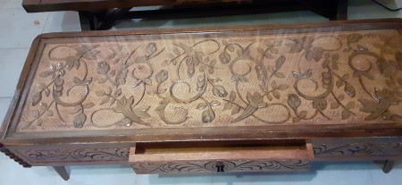 An ornately carved wooden coffee table.
