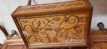 The carved drawer on a wooden table.