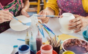 Painting a ceramic plate and vase.