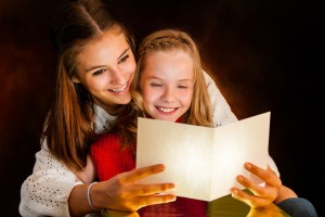 A mother and daughter reading a poem at Christmas time.