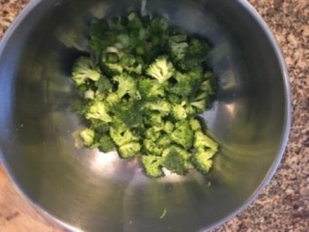 Cut up broccoli in a mixing bowl.