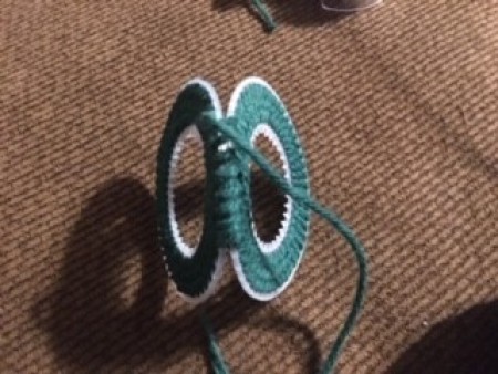 Attaching the two plastic canvas pieces together with yarn.