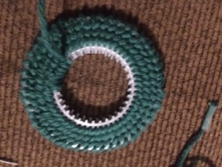 Attaching the two plastic canvas pieces together with yarn.