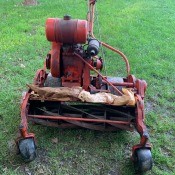 A vintage mower on a lawn.