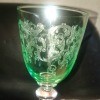 A green glass goblet with a clear stem.