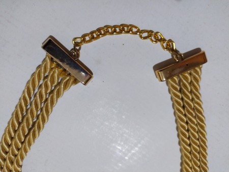 Attaching a clasp and chain to the ends of the cords.