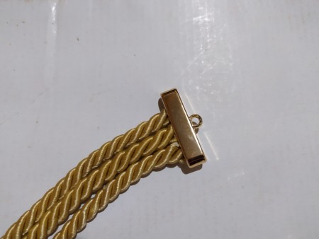 Attaching a clasp to the ends of the cords.