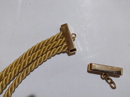 Attaching a clasp to the ends of the cords.