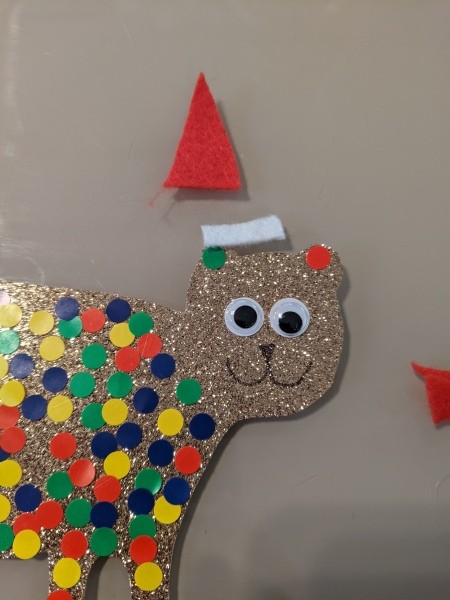 Cutout pieces of felt for a Santa hat.