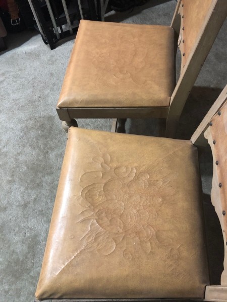 The leather seats of two chairs.