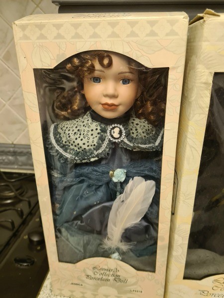 A porcelain doll in original packaging.