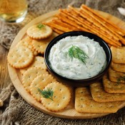 Cream cheese dip surrounded by crackers.