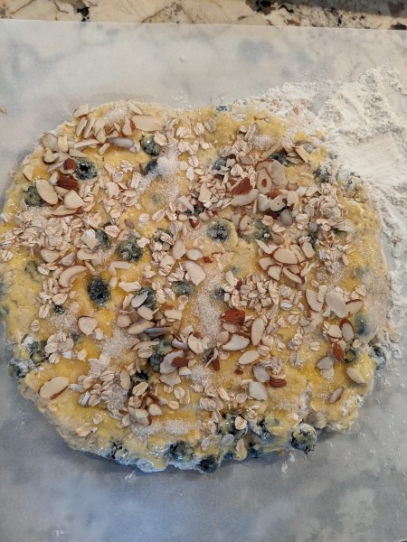 Adding the egg yolk to the top of the scone batter.