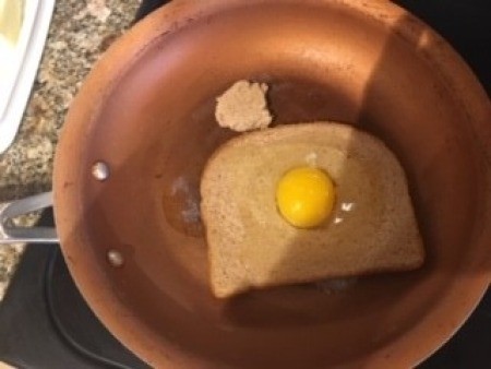 Cooking the bread with filled egg hole.
