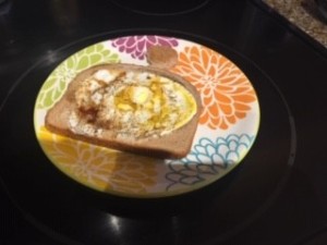 A plate containing a cooked Toad in the Hole