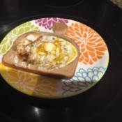 A plate containing a cooked Toad in the Hole