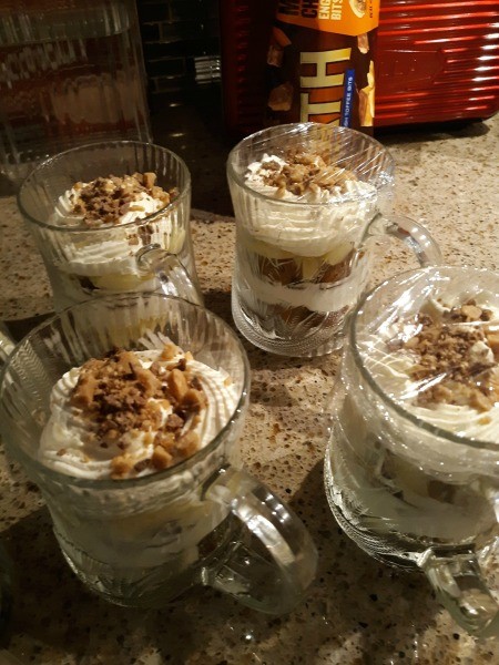 Decorative glass mugs filled with trifle.
