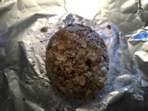 A cheese ball covered in almonds