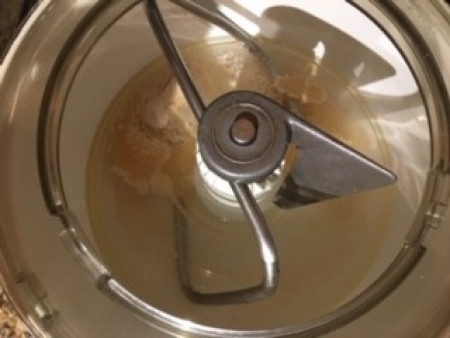 Adding bread ingredients in a food processor.